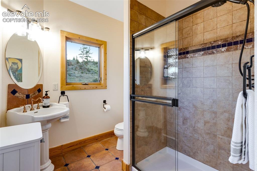 Image 36 of 50: bath, pedestal sink, tile flooring and backsplash and bidet with soft-close