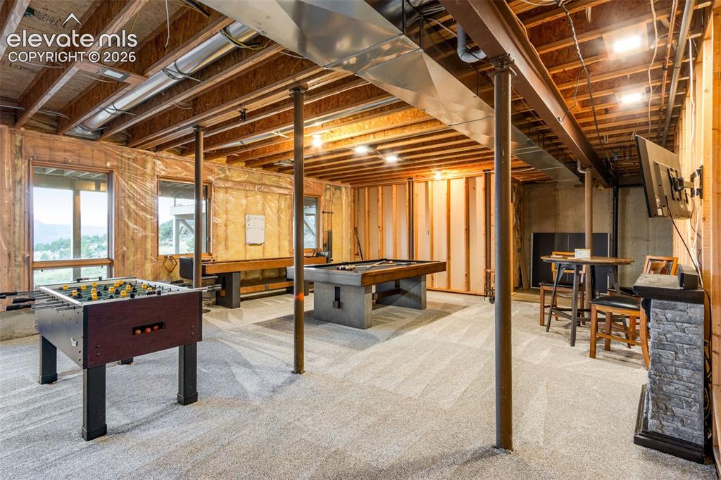 Image 43 of 50: The walk-out basement is the perfect gathering spot for pool, foosball, and