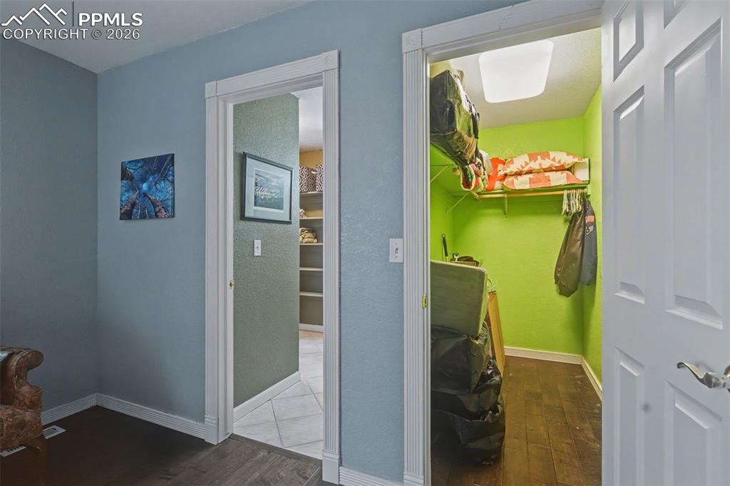 Image 28 of 42: Closet & attached bath in bedroom 2