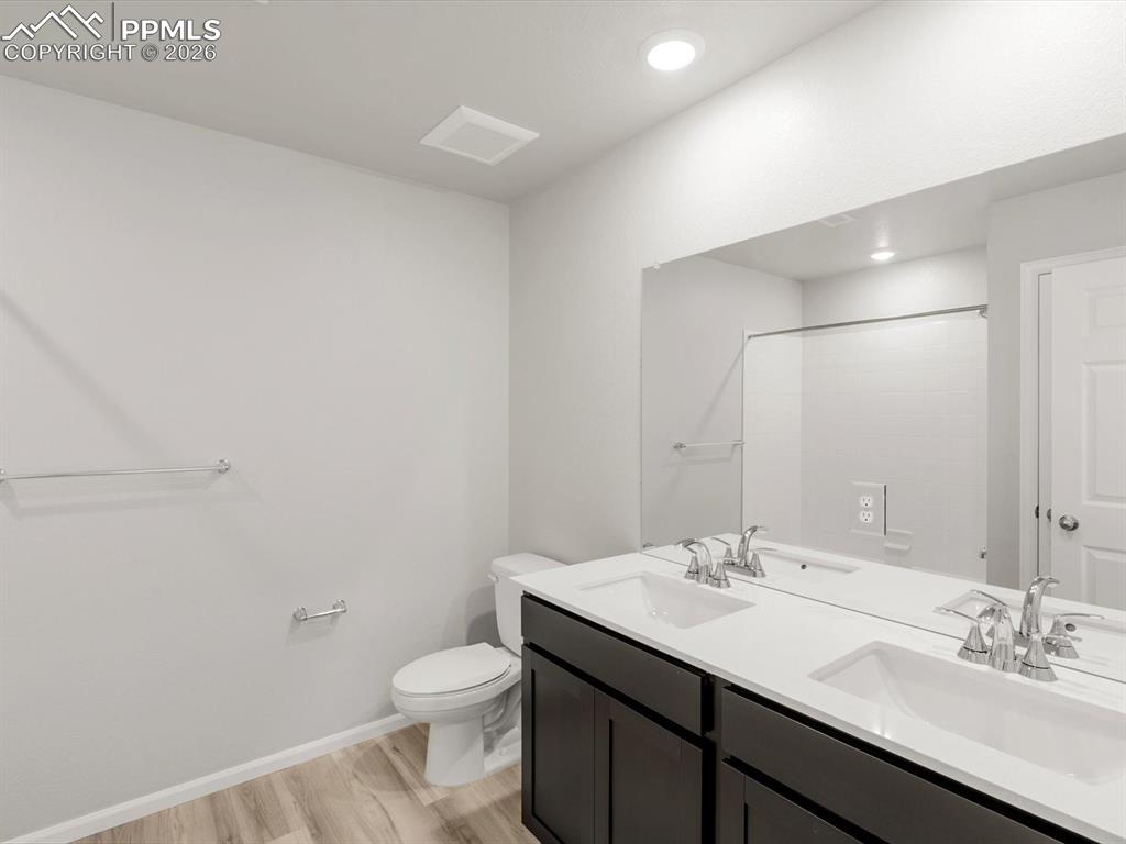 Image 10 of 16: Bathroom featuring light wood-type flooring and double vanity