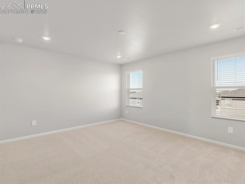 Image 5 of 16: Unfurnished room with light colored carpet and recessed lighting
