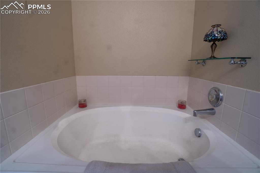 Image 22 of 40: Bathroom with a garden tub