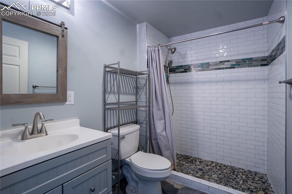 Image 32 of 40: Full bathroom with vanity and a stall shower
