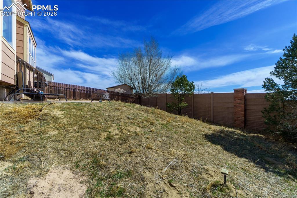 Image 37 of 40: View of fenced backyard