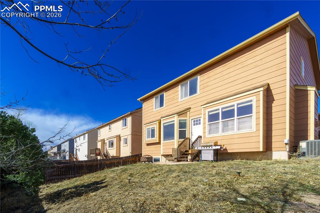 Image 39 of 40: Rear view of house with entry steps