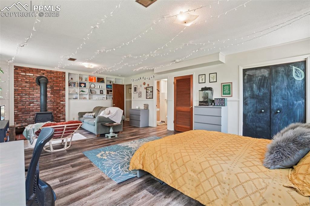 Image 12 of 49: Huge primary bedroom with en suite bathroom and wood burning stove!
