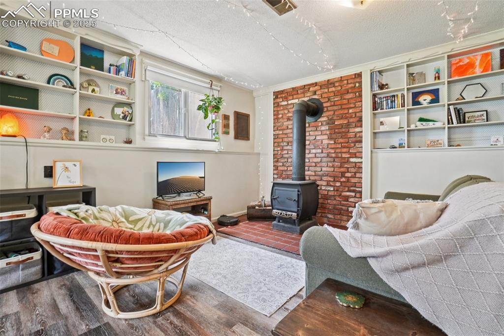Image 16 of 49: Sitting area and wood burning stove in the primary bedroom