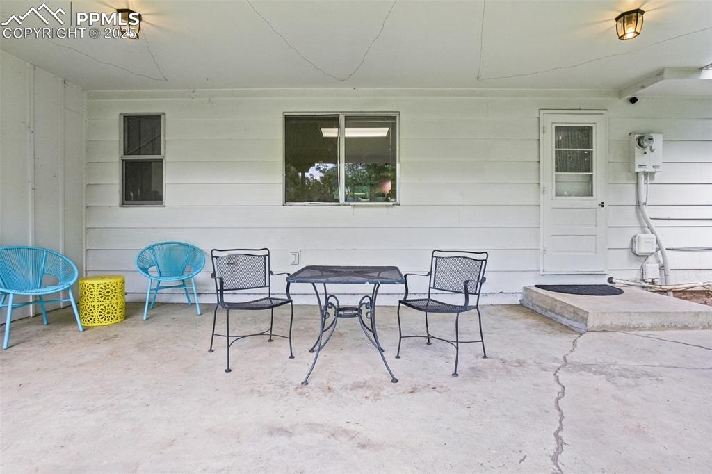 Image 27 of 49: Large covered patio off of the kitchen
