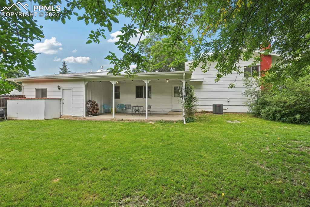 Image 34 of 49: View of the backyard and one of several storage sheds
