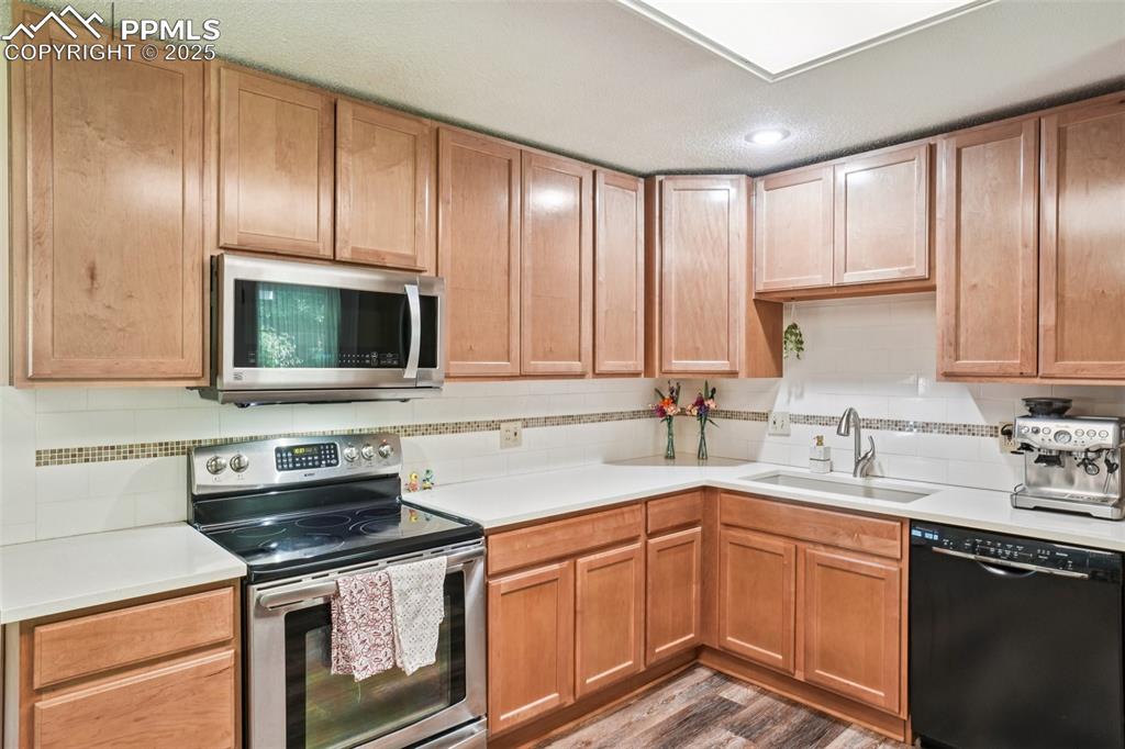 Image 9 of 49: Updated kitchen with quartz counters and a custom backsplash!
