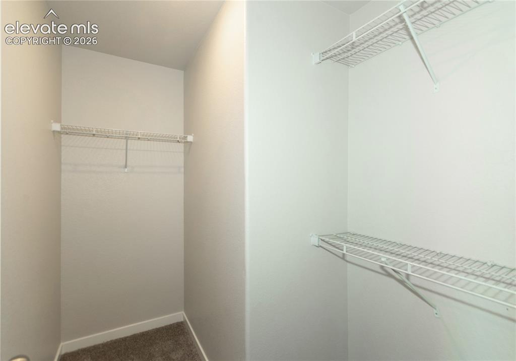 Image 13 of 20: primary walk in closet, there are 2 of them