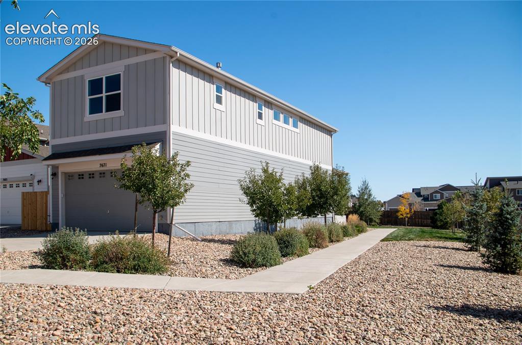 Image 19 of 20: side of house with 2 car garage