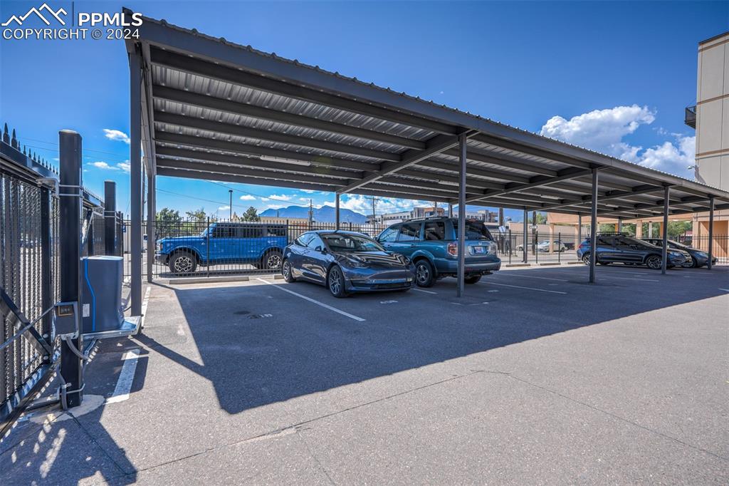 Image 49 of 50: Covered parking in gated area.