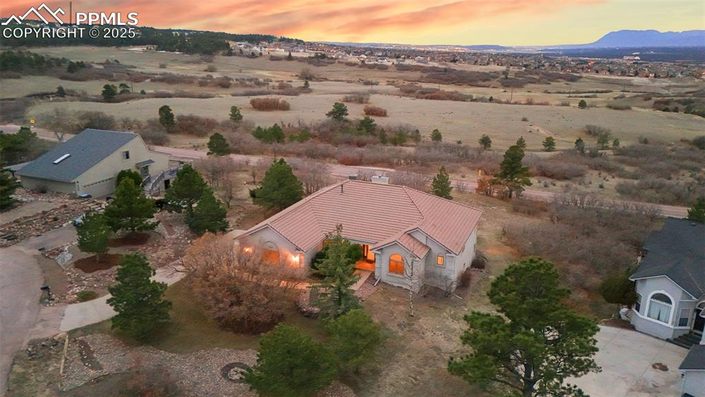 Caption: Aerial view at dusk with a mountain view