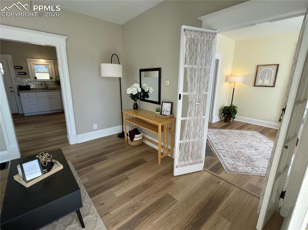 Image 2 of 30: House Living Room with high ceilings and French doors to Bedroom 2