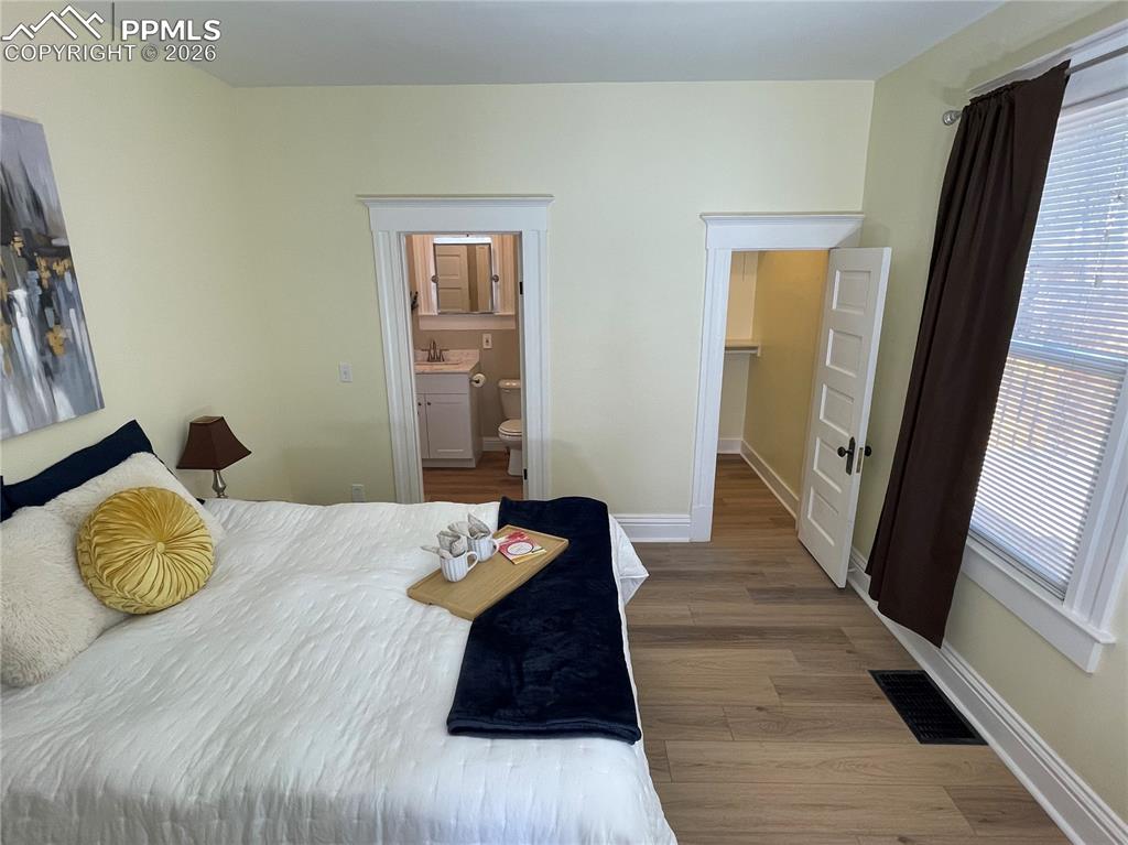 Image 27 of 30: House Bedroom 1 with ensuite (shown with a Queen Size bed)