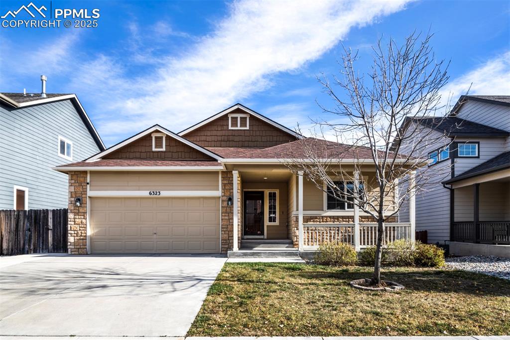 Caption: View of front of property featuring a porch, concrete driveway, and 2 car attached garage