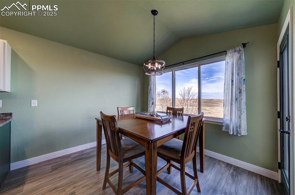 Image 14 of 45: Dining room with gorgeous views,  walk-out to back deck, luxury vinyl floor