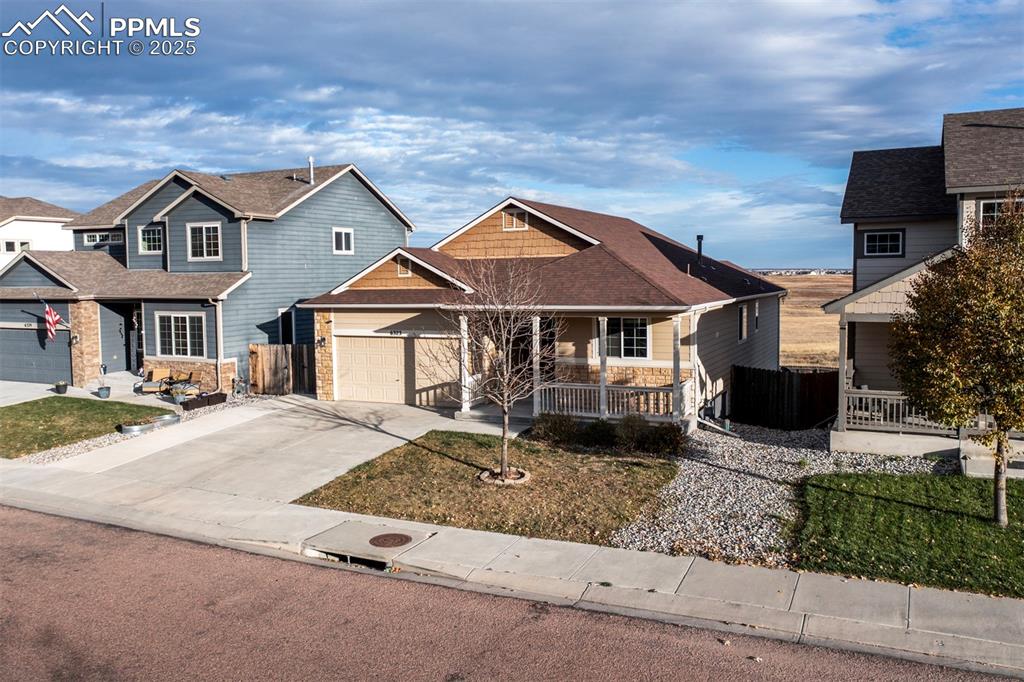 Image 2 of 45: View of front of property featuring stone siding and covered porch