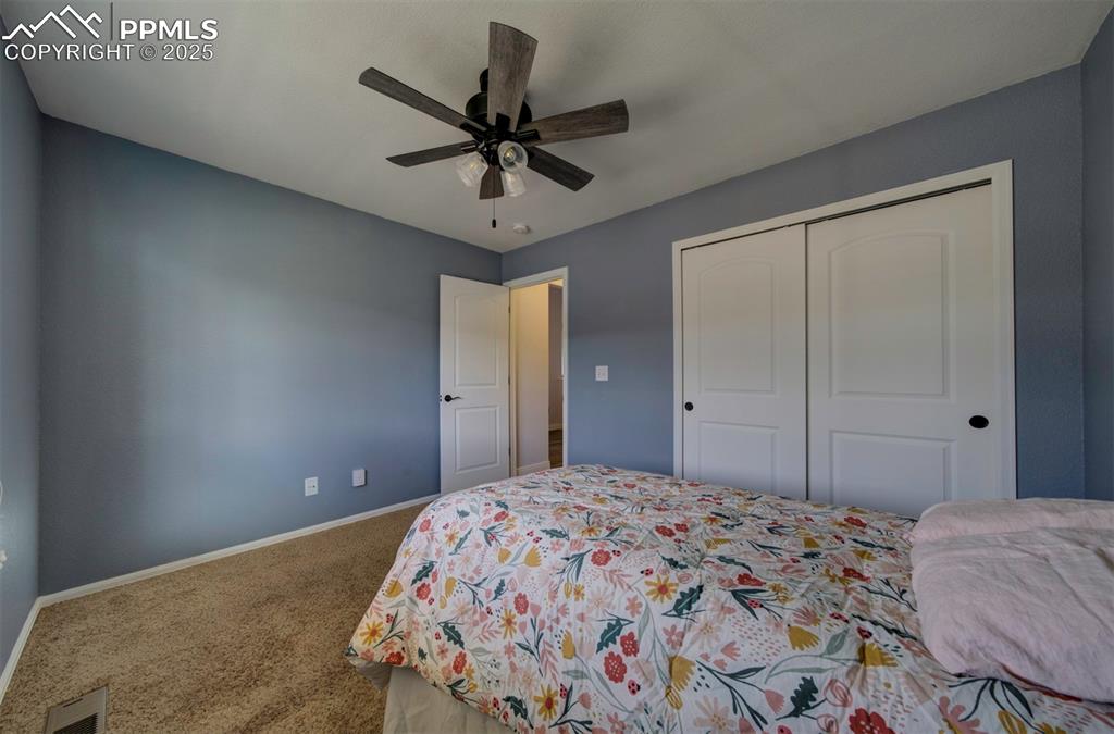 Image 22 of 45: Bedroom with carpet, ceiling fan, and a closet