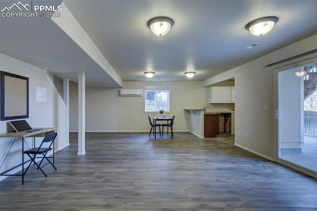 Image 27 of 45: Family room in basement w/ kitchenette/wet bar, sliding glass door to backy
