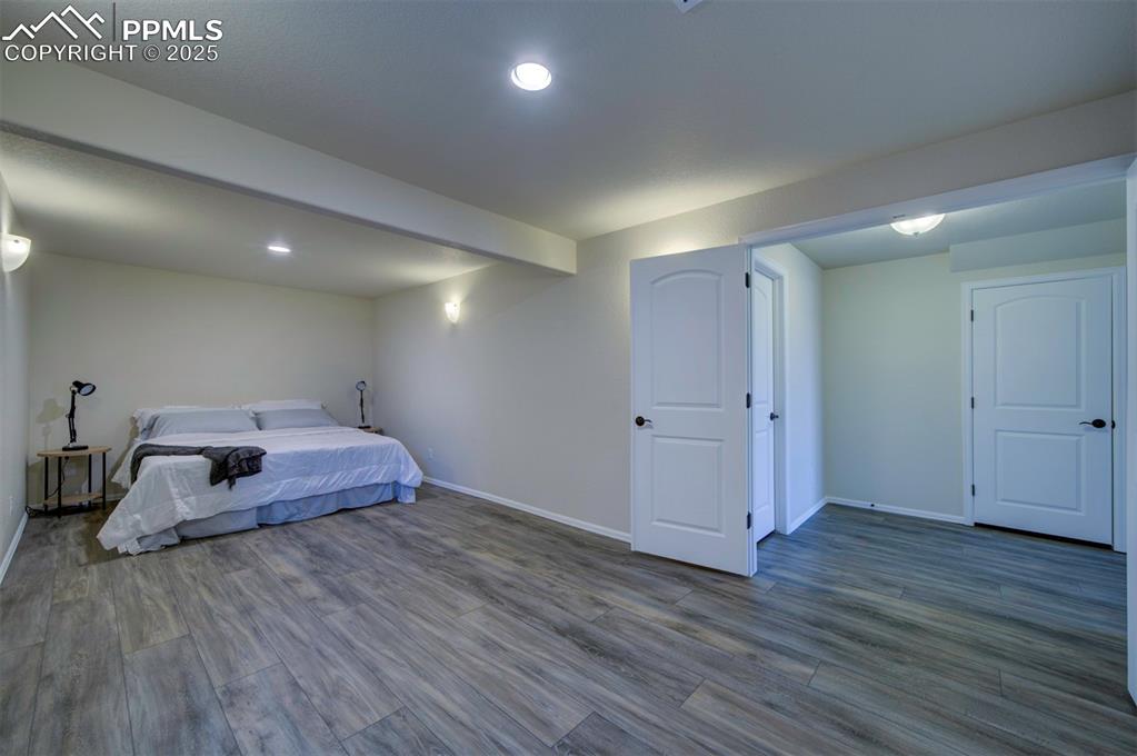 Image 34 of 45: Bedroom in basement with luxury vinyl flooring, recessed lighting, and larg