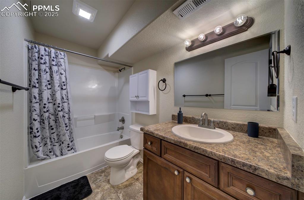 Image 36 of 45: Full bath in basement featuring shower / bathtub combination and vanity.