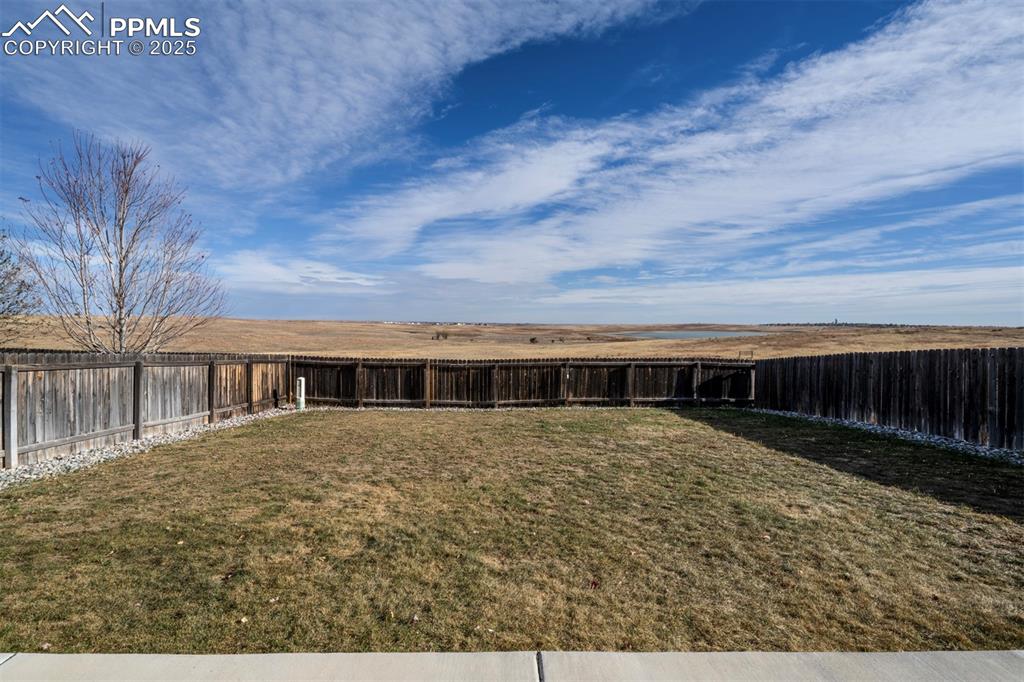 Image 38 of 45: Rear view of property featuring a fenced backyard and beautiful unobstructe