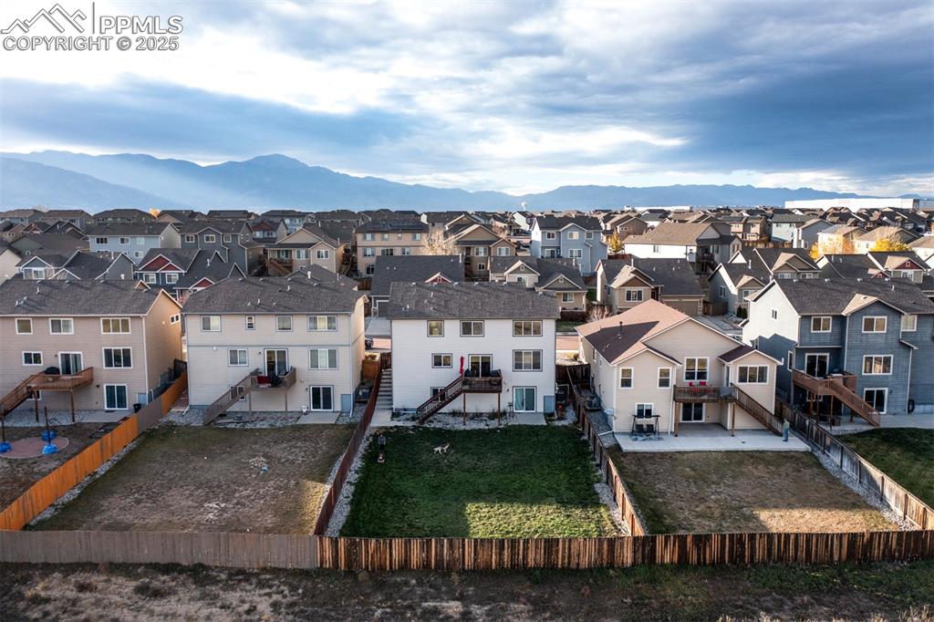 Image 40 of 45: Aerial perspective of neighborhood featuring a mountain backdrop