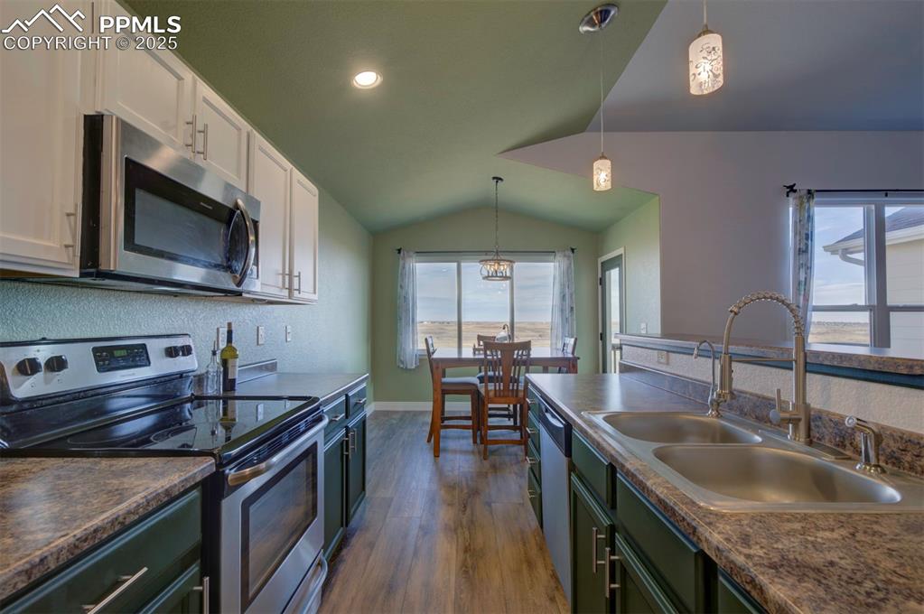Image 9 of 45: Kitchen featuring stainless steel appliances, newly painted cabinets, and n