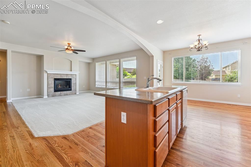 Image 21 of 46: View from open kitchen, island seating, into dining area and main living sp