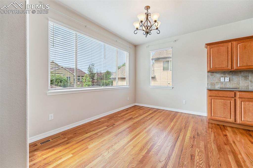 Image 22 of 46: Beautiful Hardwood floors in main floor eat in dining