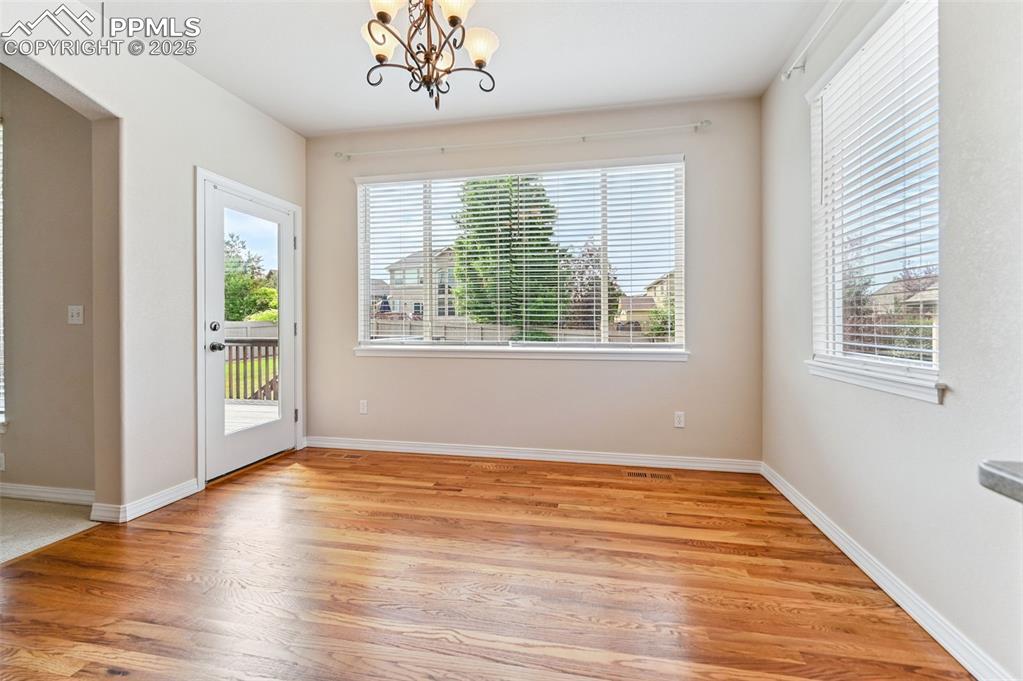 Image 23 of 46: Main floor dining area with immediate access to back deck and level yard