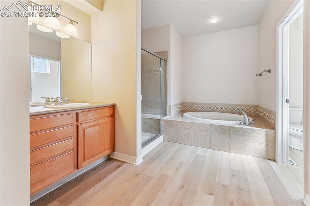 Image 27 of 46: Private access to 5 piece master bathroom with garden tub and shower