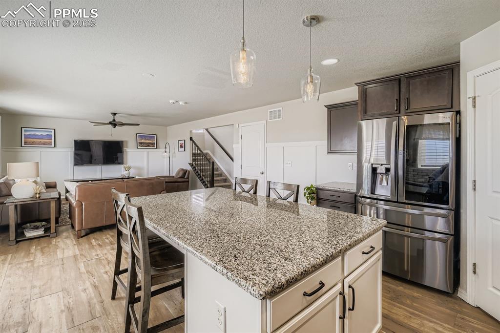 Image 11 of 42: Custom enlarged island with dining area.