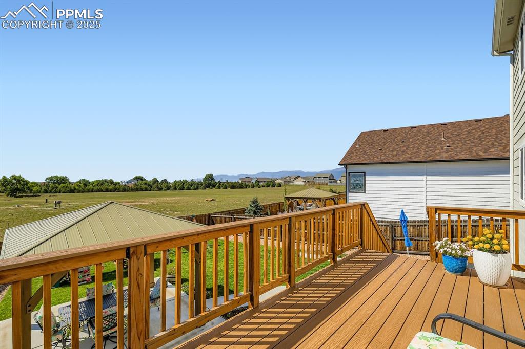 Image 27 of 42: Enlarged deck with composite material. Overlooking the gorgeous backyard.