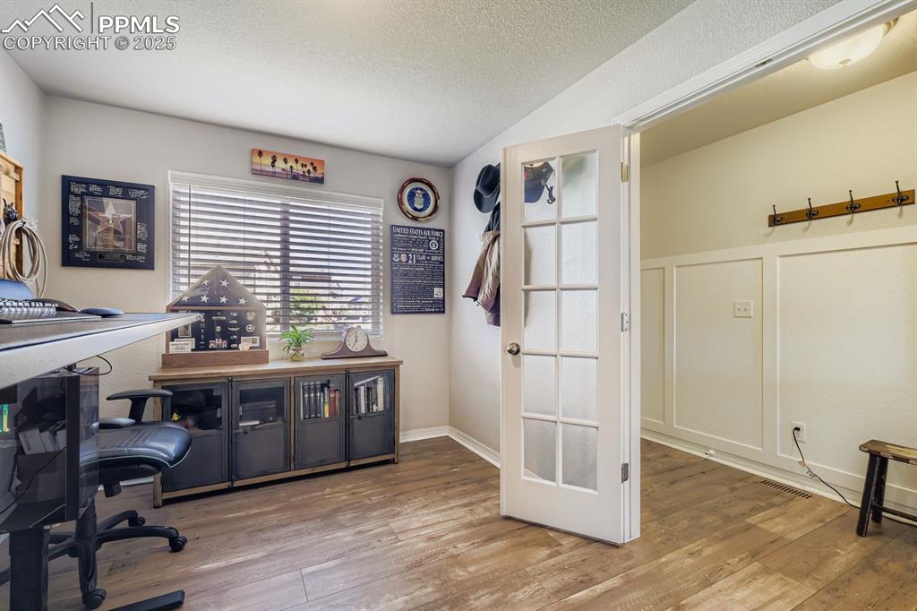 Image 7 of 42: Beautiful French doors and wainscot ascent walls throughout the main level.