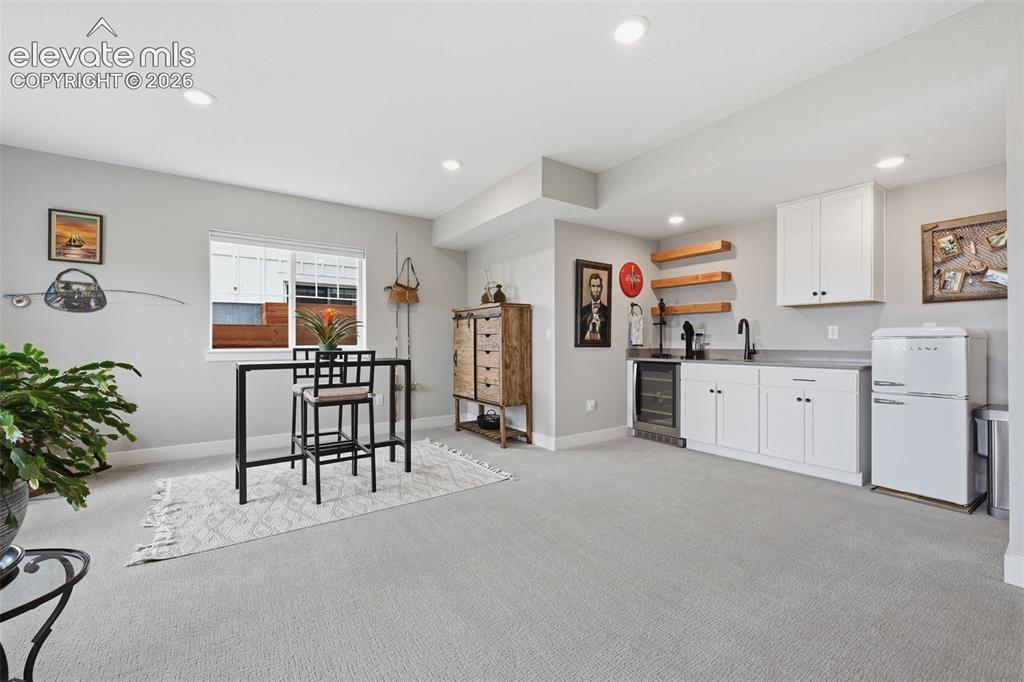 Image 29 of 50: wet bar with refrigerator and beverage fridge