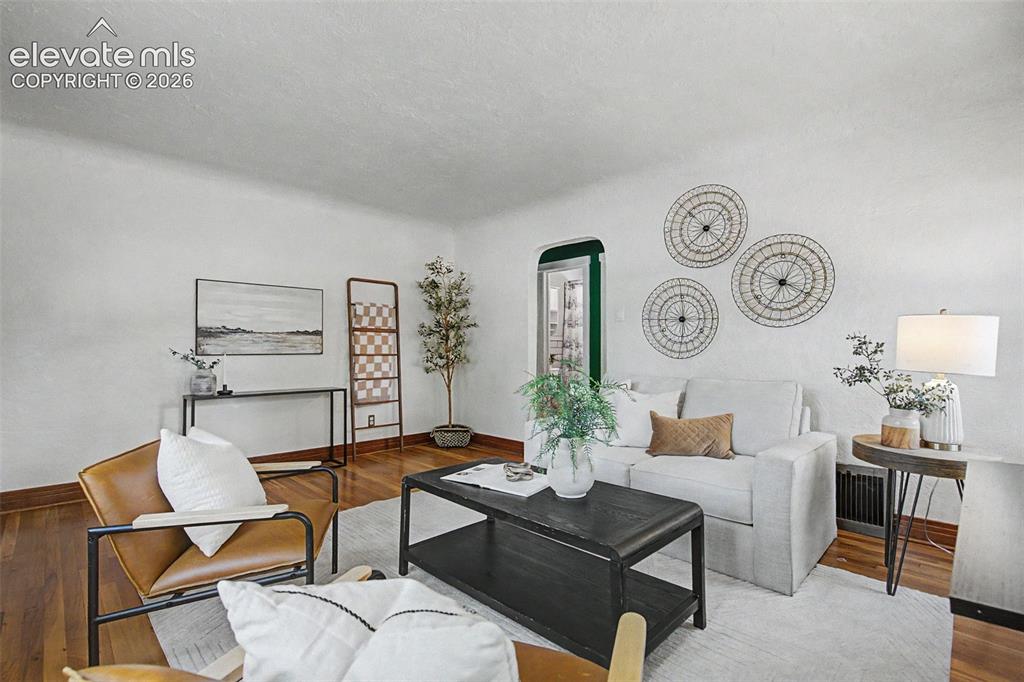Image 10 of 37: Living space featuring wood-finish flooring, white wall finishes, and a fra