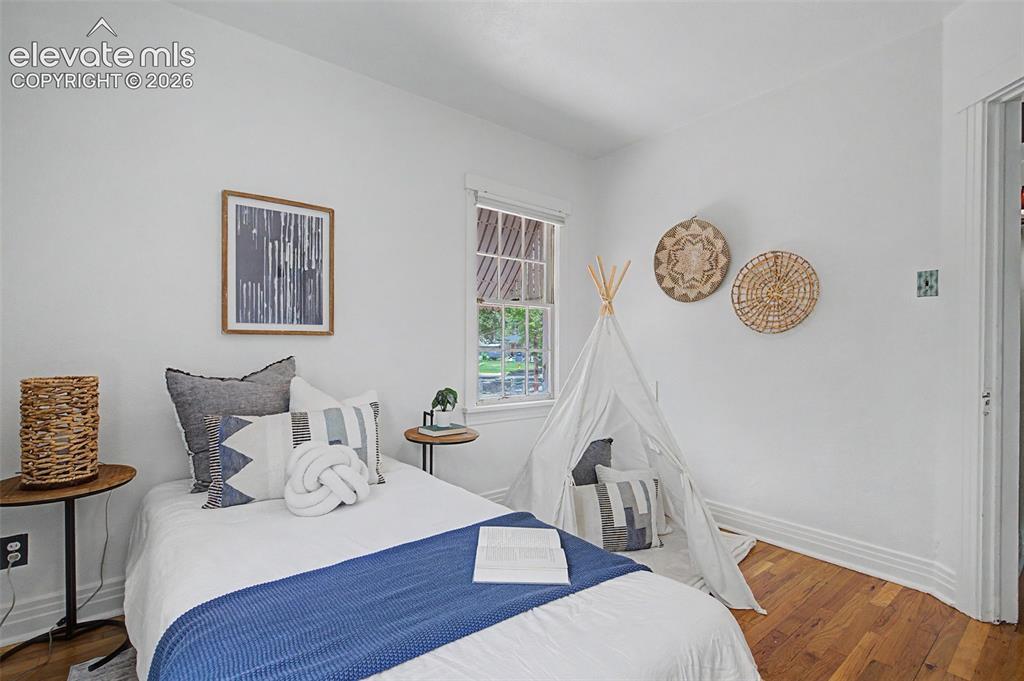 Image 20 of 37: Room featuring hardwood flooring, white walls, a single window, and a white