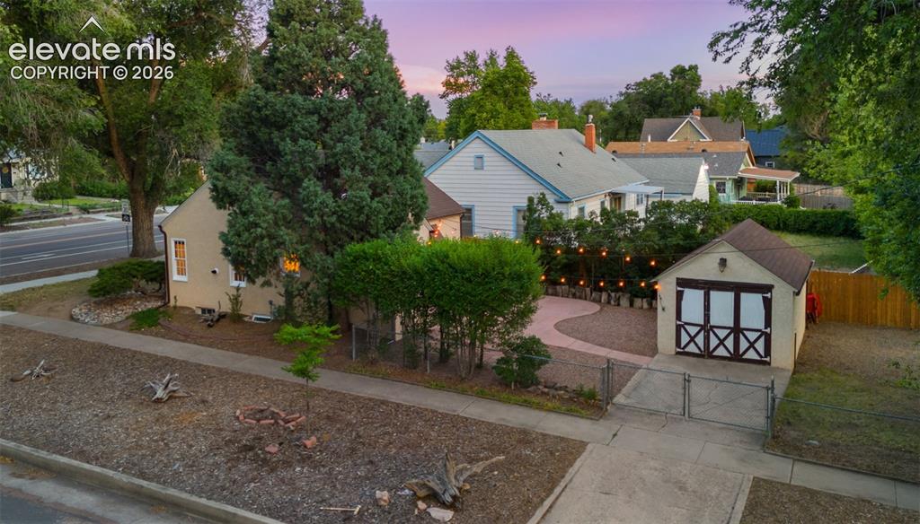 Image 3 of 37: Detached garage featuring barn-style doors and a concrete driveway
