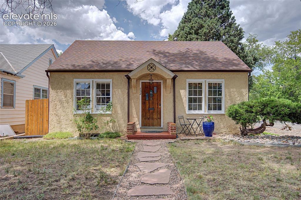 Image 37 of 37: Stucco exterior with a peaked roof