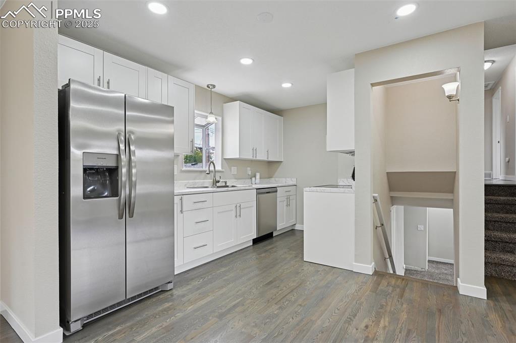 Image 10 of 36: Remolded kitchen with soft close cabinets and hardwood floors. 