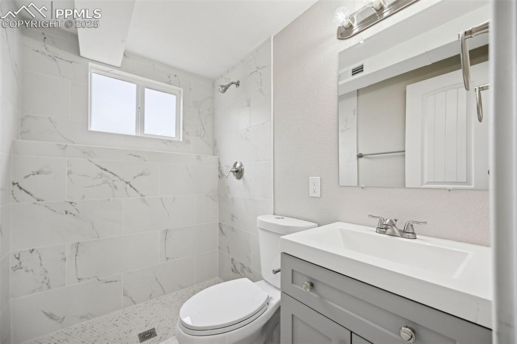 Image 27 of 36: Lower level bathroom with shower. 