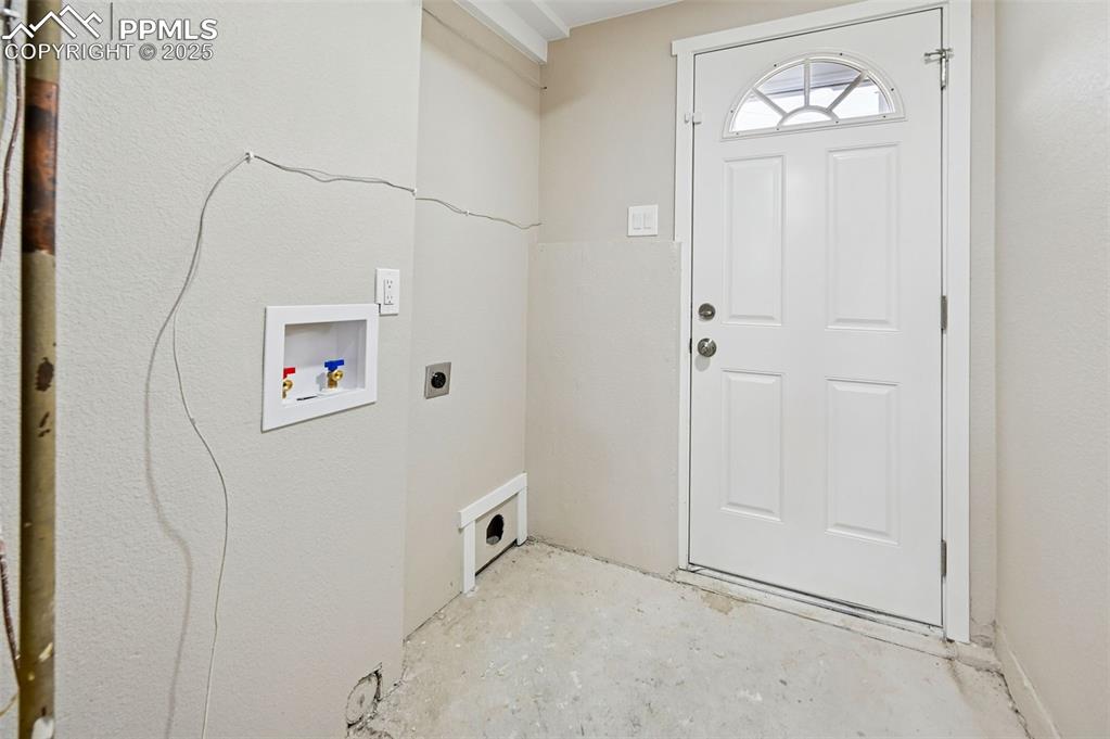 Image 30 of 36: Laundry area with walk-out