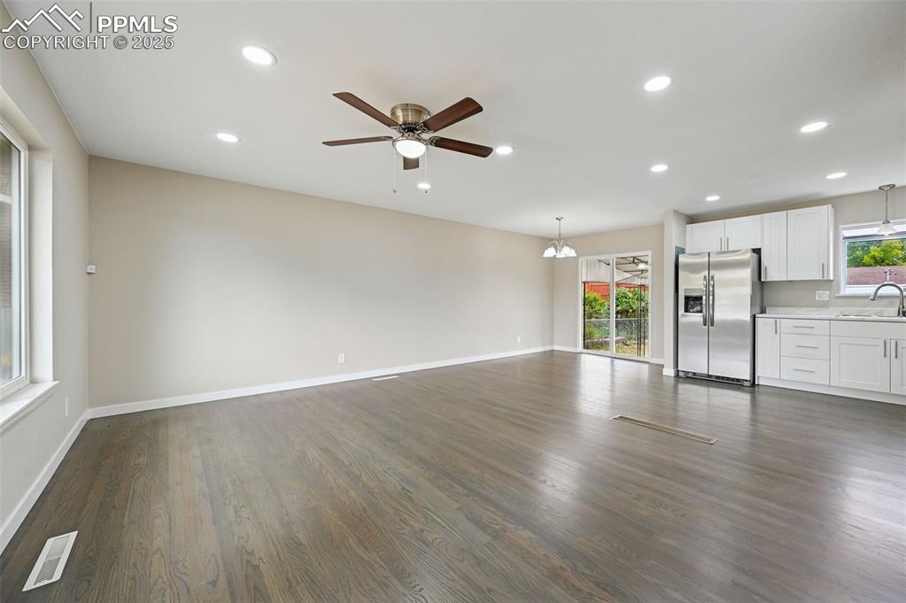 Image 4 of 36: Open living room with hard wood floors