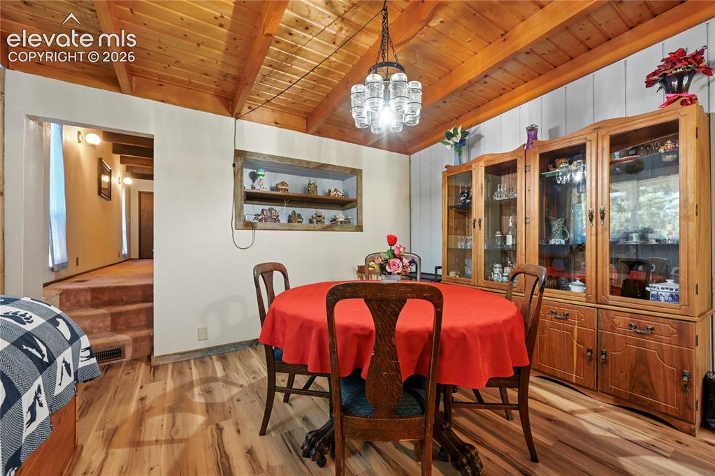 Image 22 of 50: Vaulted wood-finish ceiling with exposed beams, wood-finish flooring, built