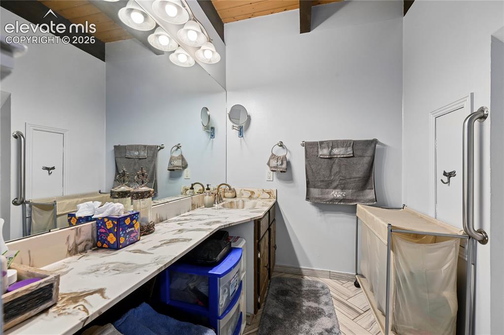 Image 31 of 50: Main bathroom Dual vanity with integrated sinks, expansive wall-mounted mir