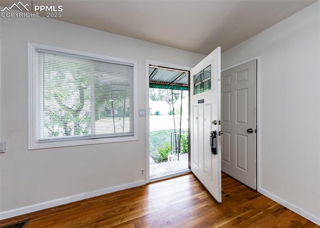Image 3 of 25: Foyer featuring plenty of natural light, wood finished floors, and baseboar