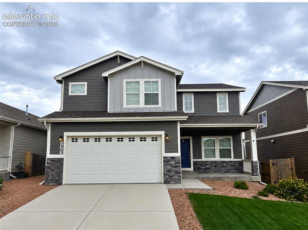 Caption: Two-story exterior with multi-toned siding and stone accents